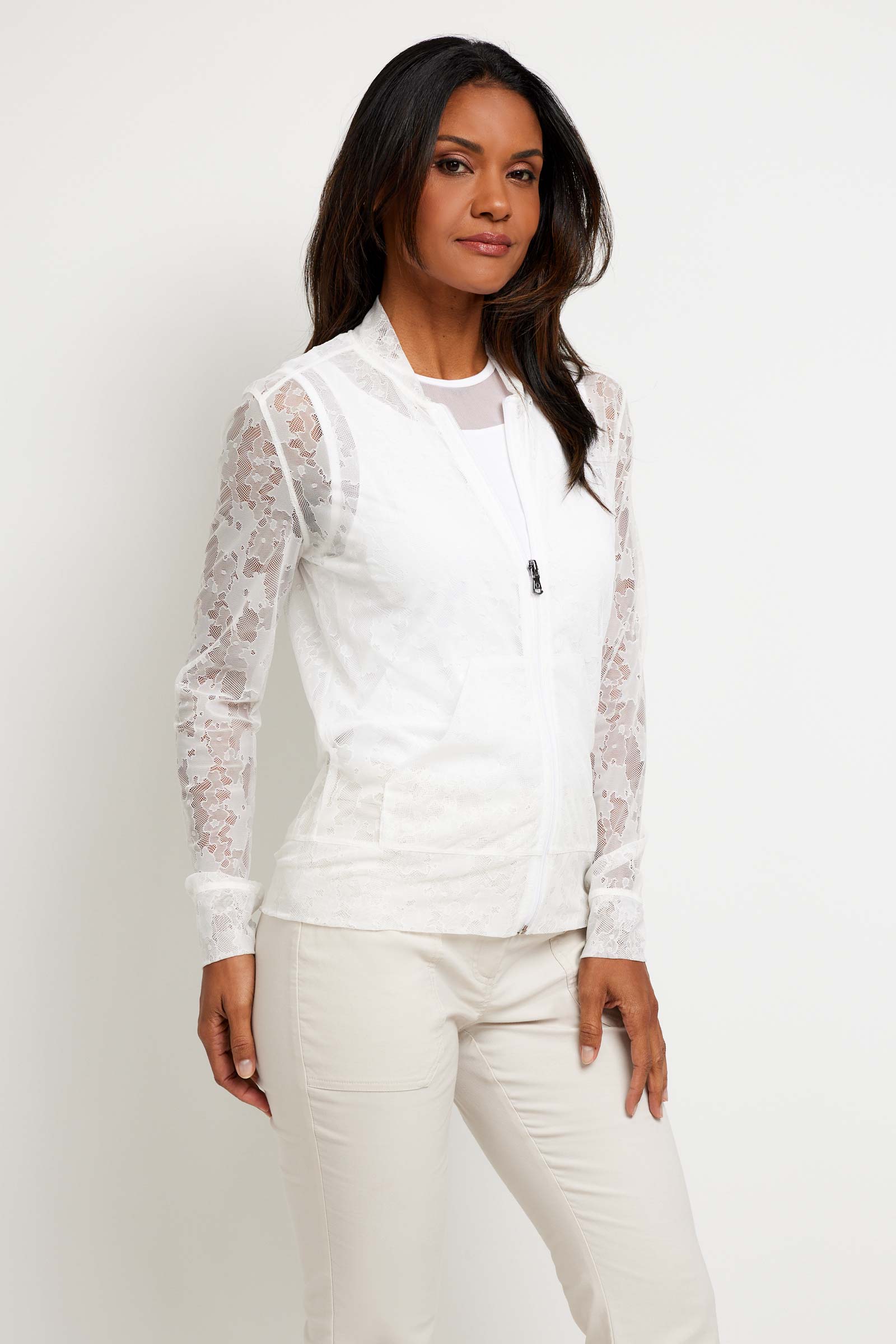 The Best Travel Jacket. Woman Showing the Side Profile of a Bailey Camo Mesh Jacket in White.