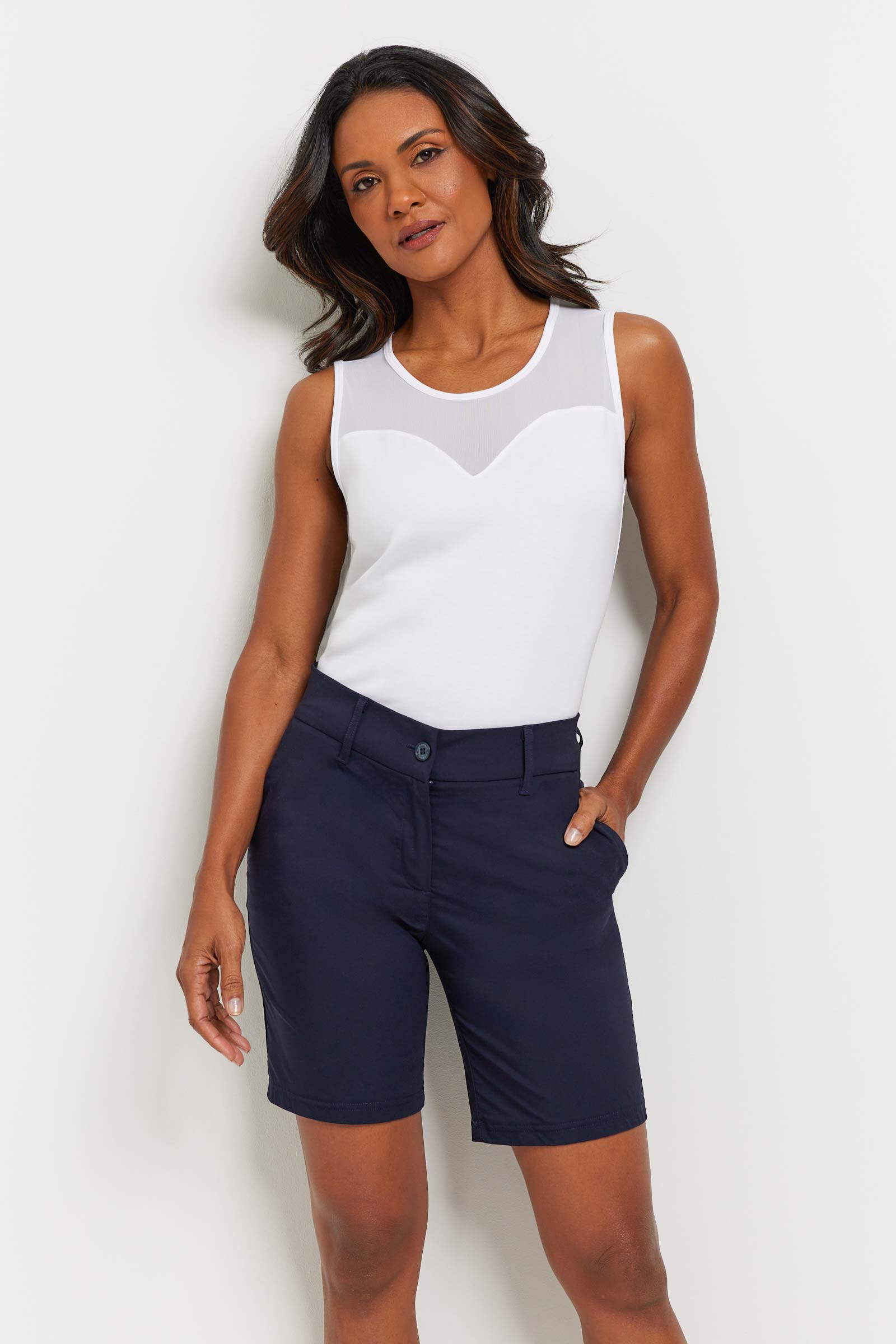 The Best Travel Short. Woman Showing the Front Profile of a Breck Performance Cotton Short in Navy.