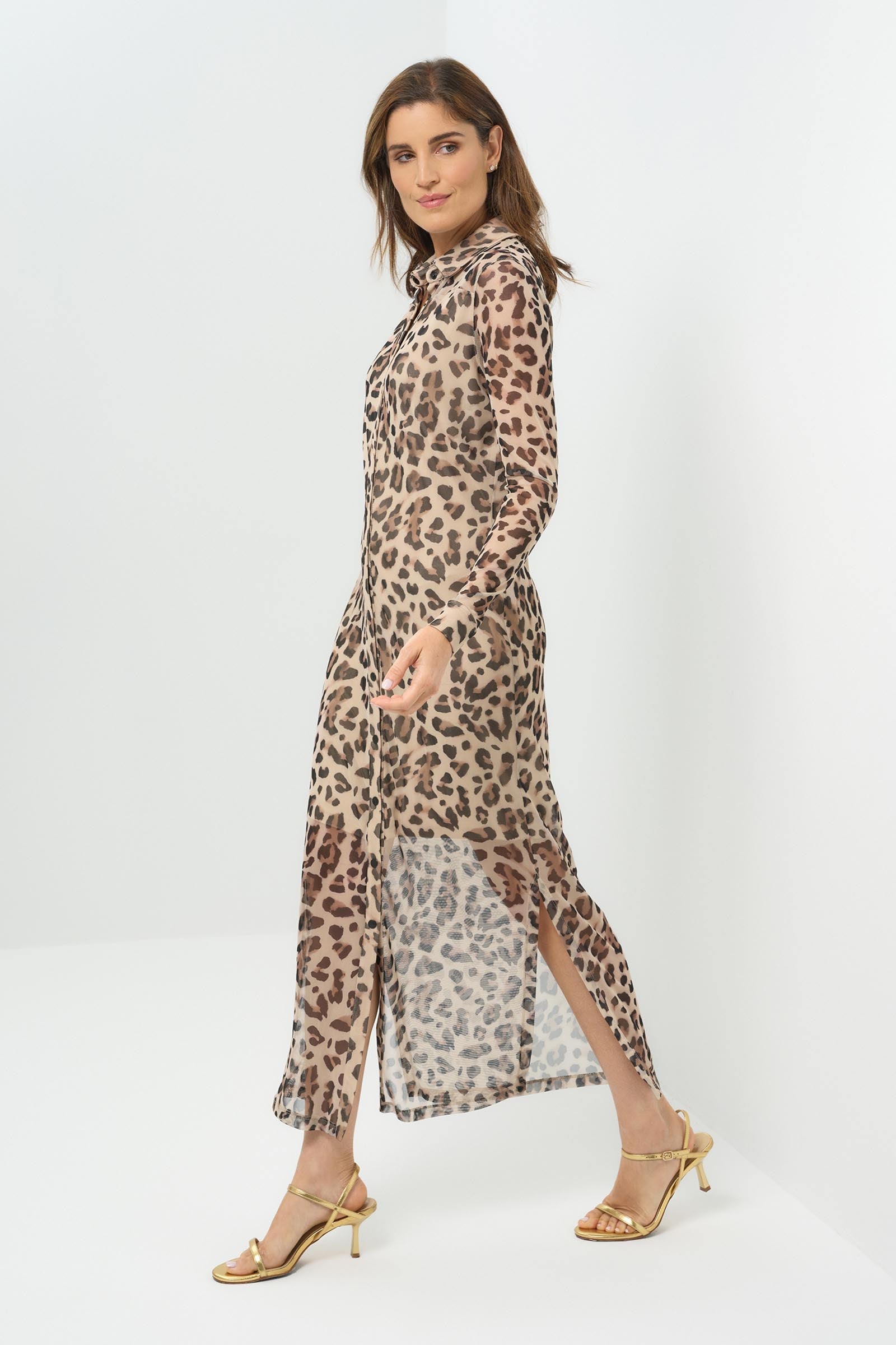 Side view sheer cheetah-print button-down dress featuring a classic collar, long sleeves, and a side slit for added movement. The lightweight fabric