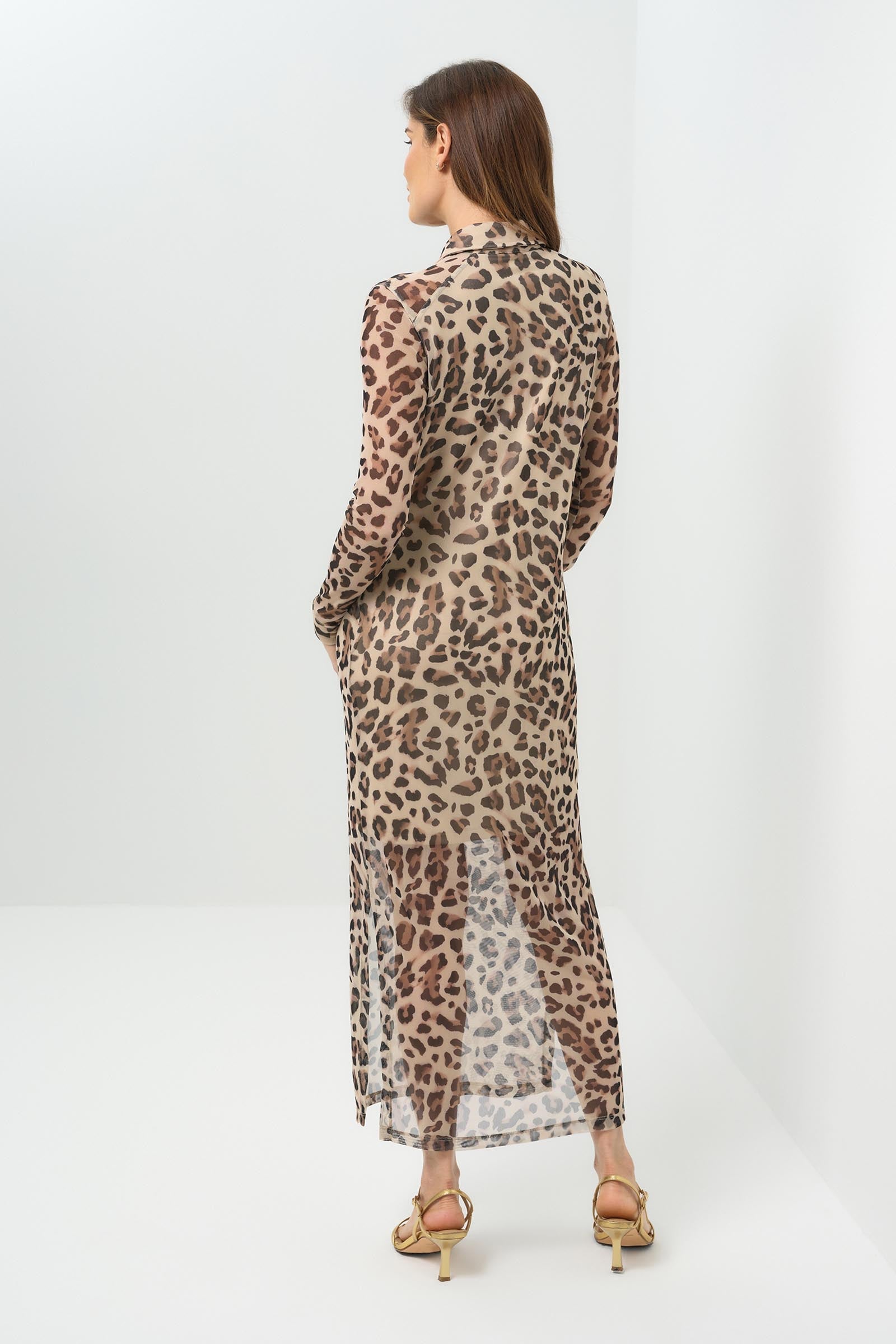 Back view sheer cheetah-print button-down dress featuring a classic collar, long sleeves, and a side slit for added movement. Made from lightweight fabric for an effortlessly chic look.