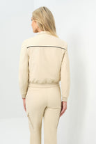 Back view of cream bomber jacket with black pinstripe detailing zipped up to collar
