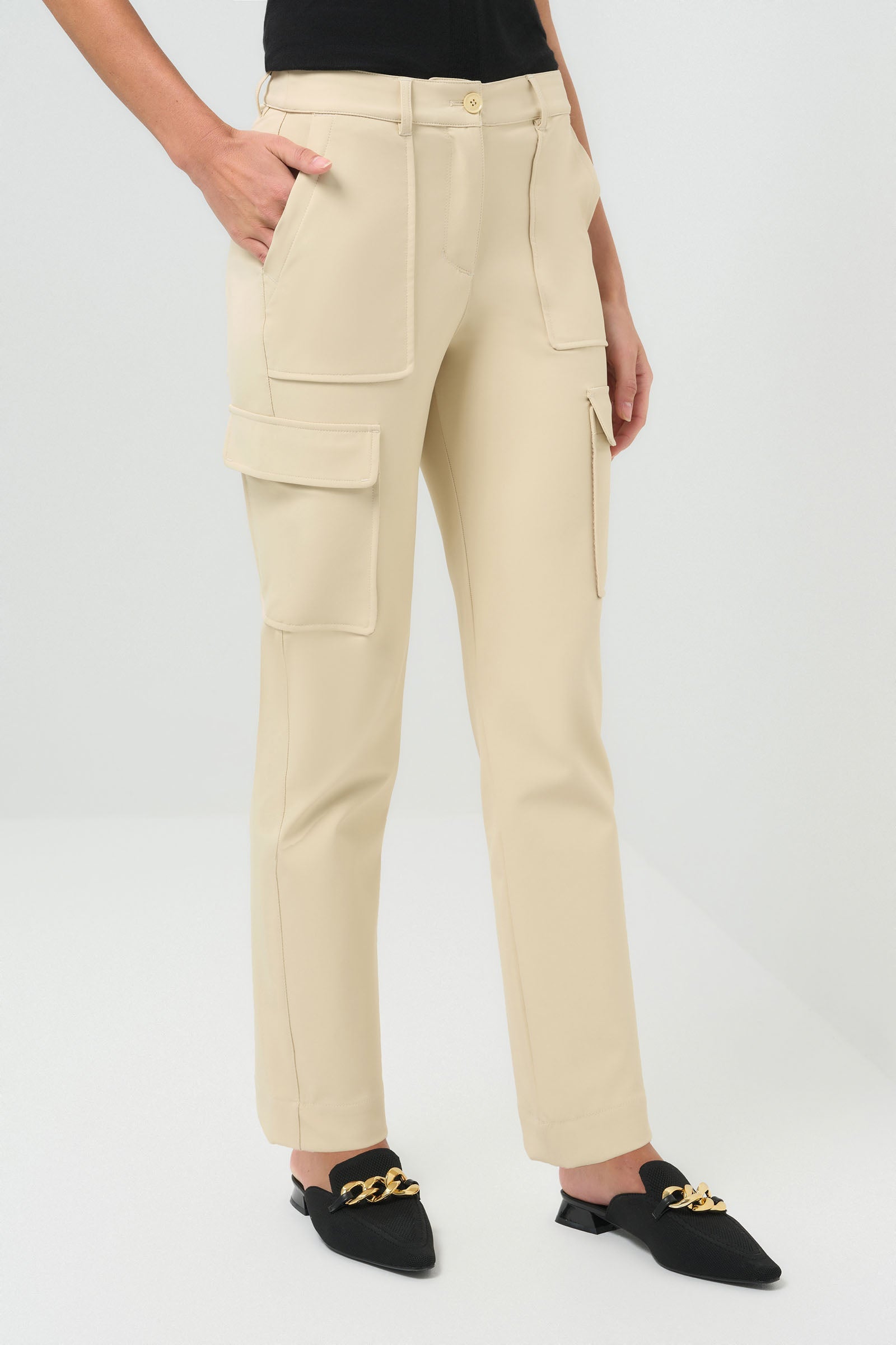 Side view of cream-colored slim-fit cargo pants, featuring a detailed shot of the pockets.