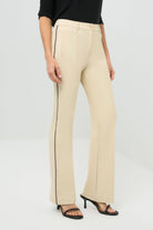 Side view of wheat pants with a black stripe on the side.