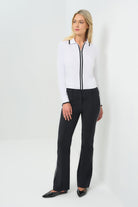 Front view black high-waisted tailored pants featuring a slim fit through the thigh and a subtle flare at the hem. Designed with clean front seams and accented by contrast side stripes for a modern, elongating effect.