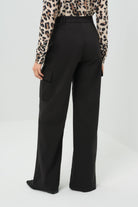 A back-facing look at the wide-leg pants, showcasing their flowing silhouette and relaxed fit.