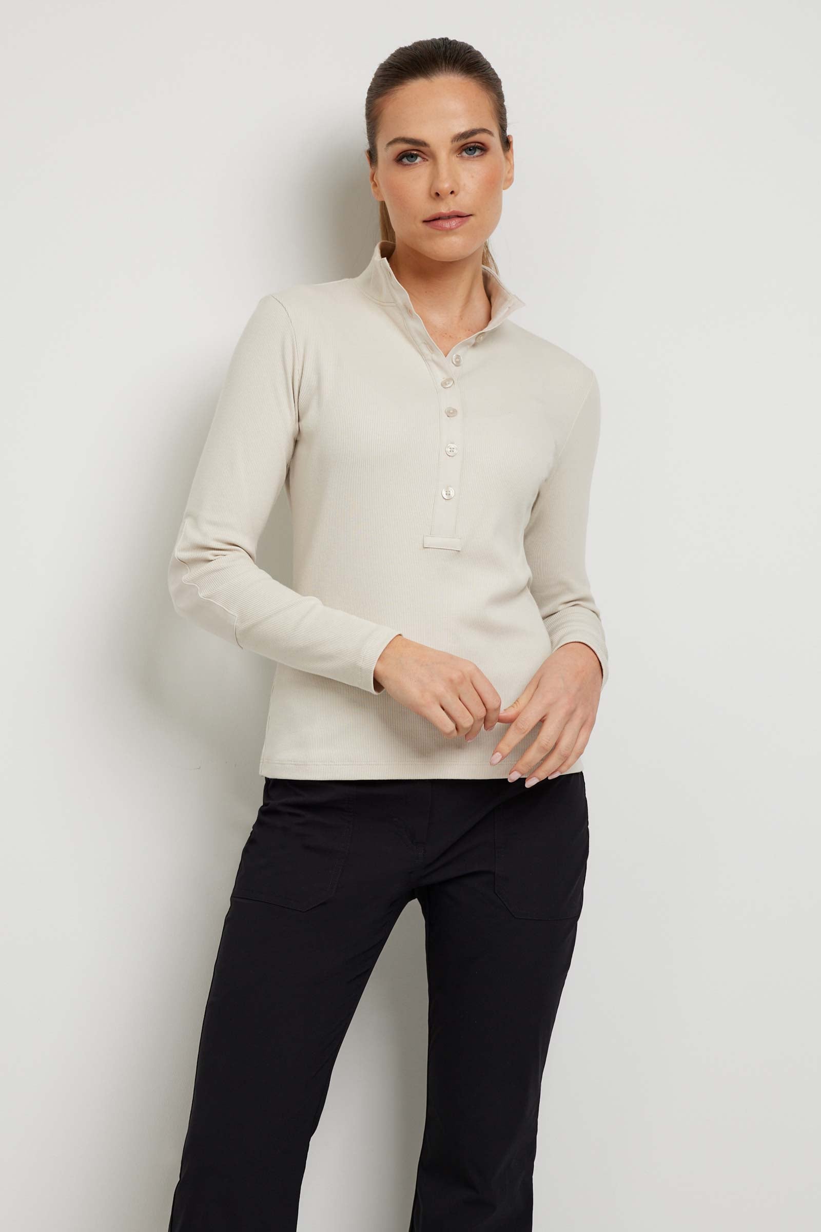 The Best Travel Top. Woman Showing the Front Profile of a Monroe Henley Top in Stone.