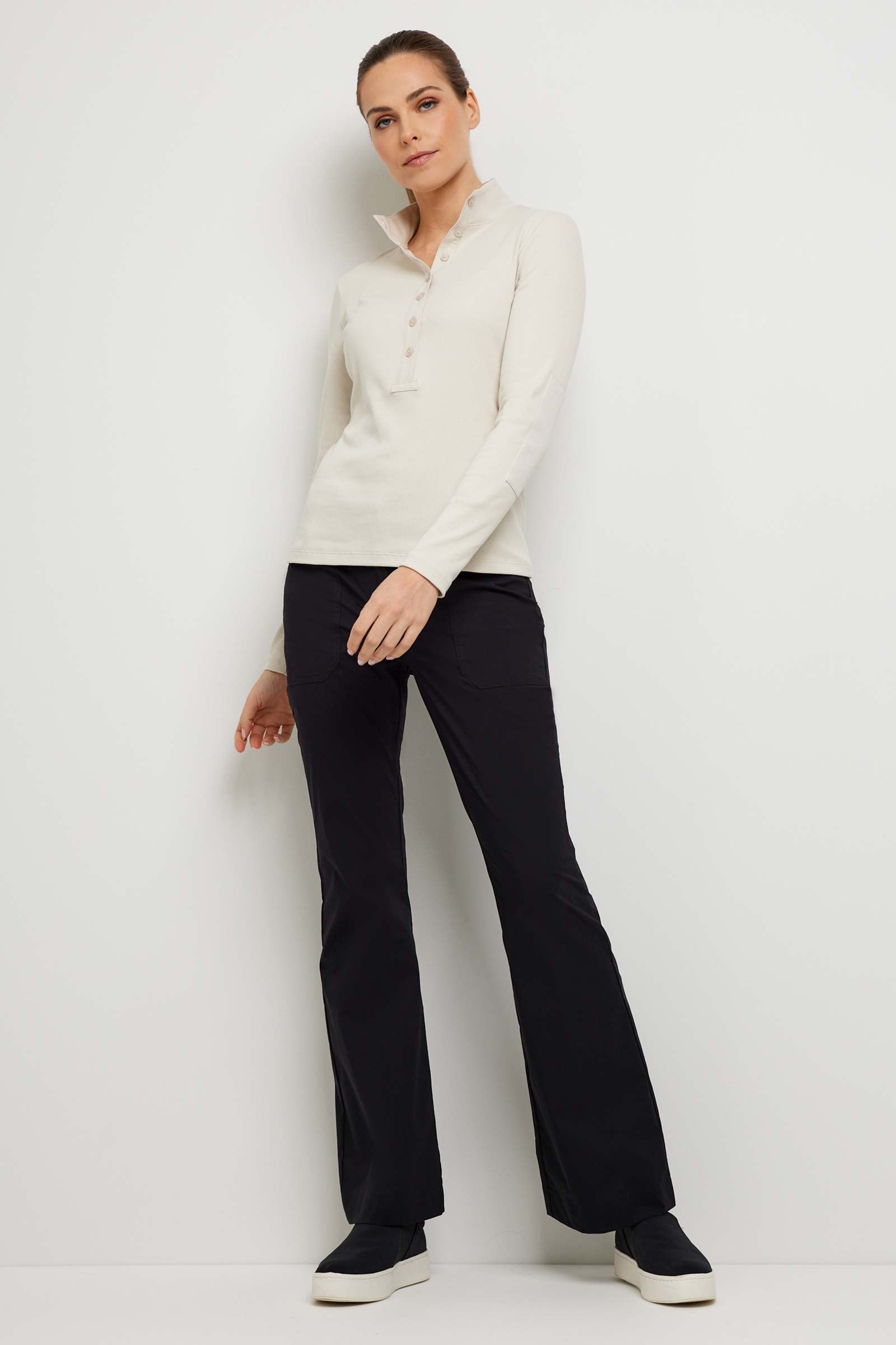 The Best Travel Top. Woman Showing the Front Profile of a Monroe Henley Top in Stone.