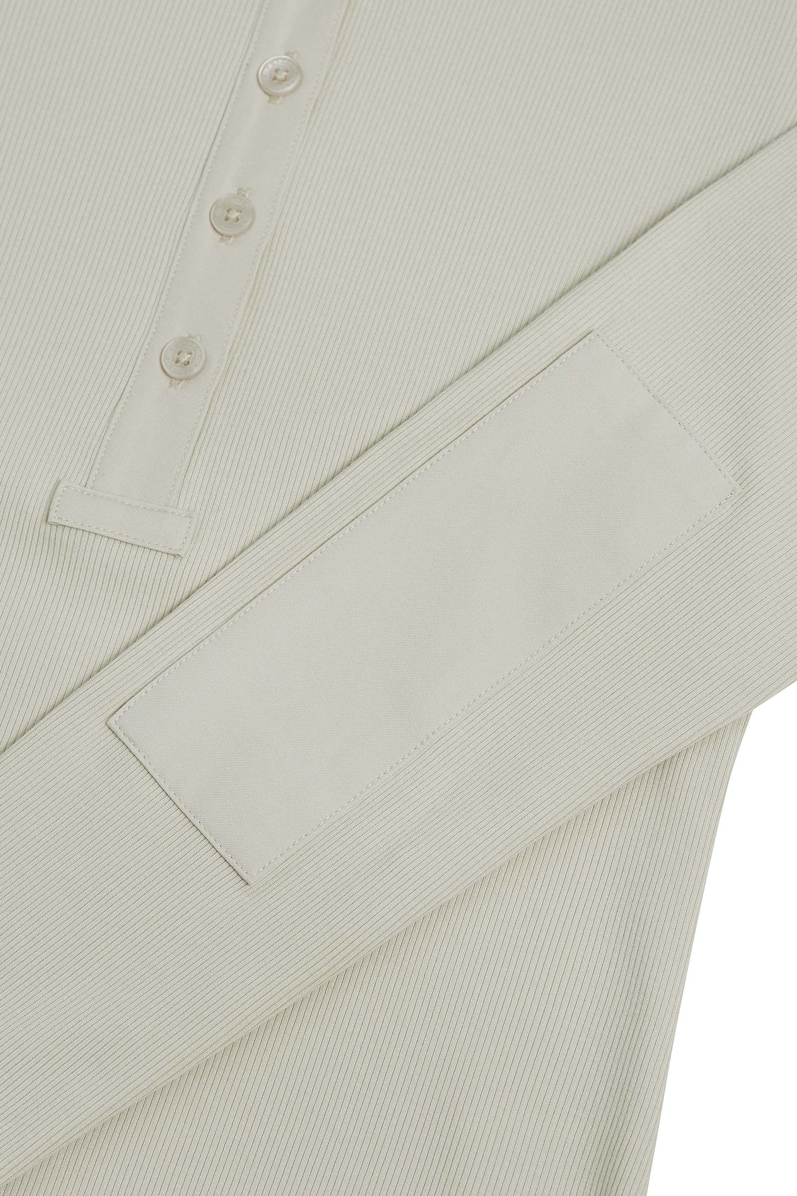 The Best Travel Top. Sleeve Detail of a Monroe Henley Top in Stone.