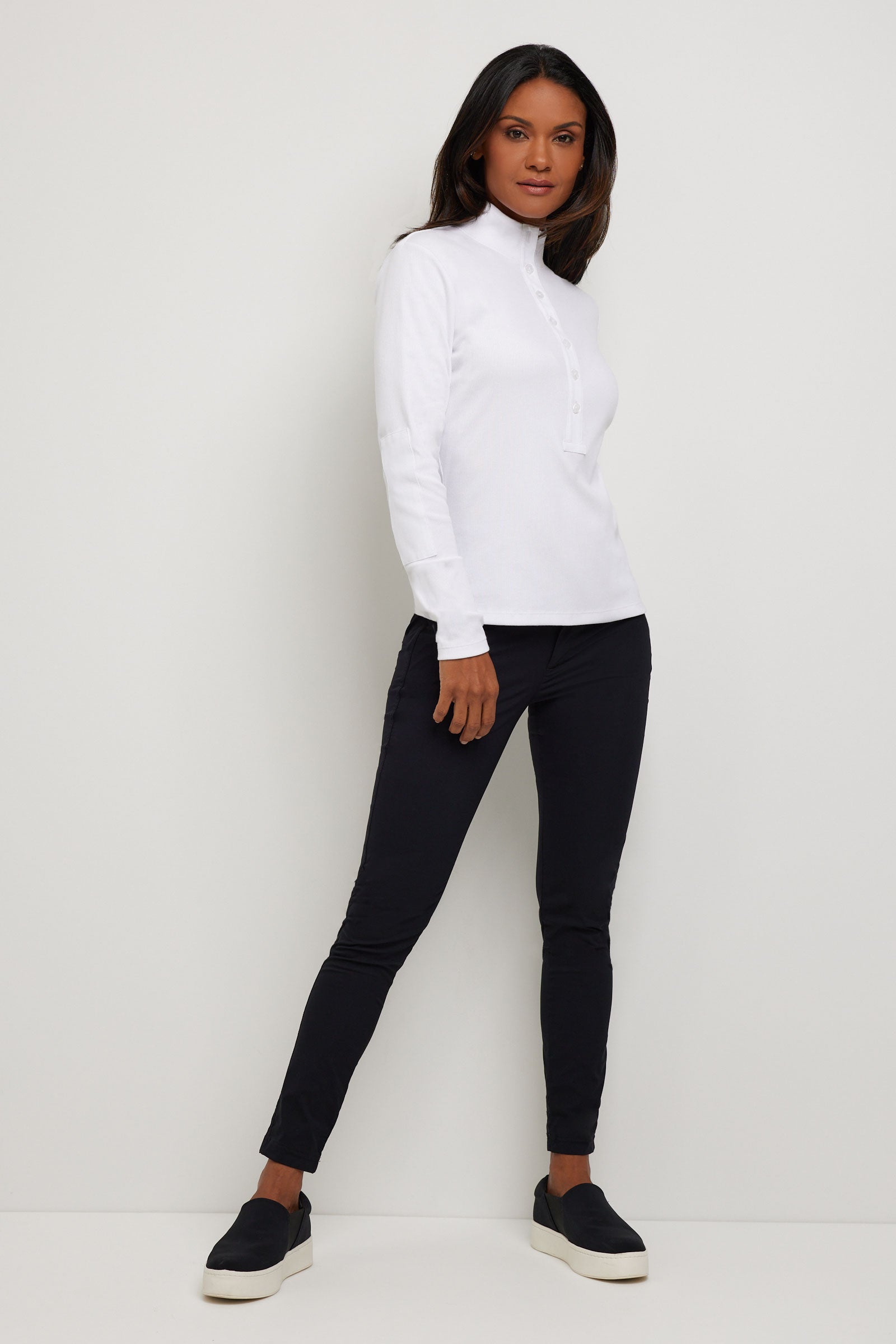 The Best Travel Top. Woman Showing the Front Profile of a Monroe Henley Top in White.