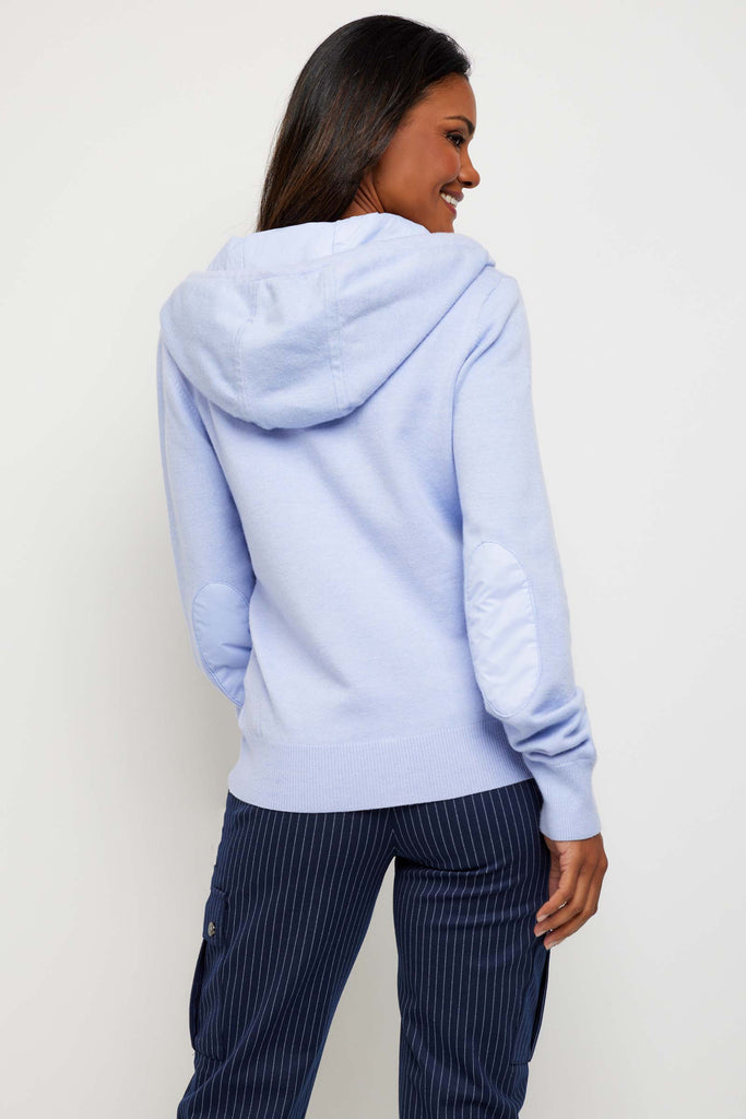 The Best Travel Jacket. Woman Showing the Back Profile of a Thalia Jacket in Periwinkle.