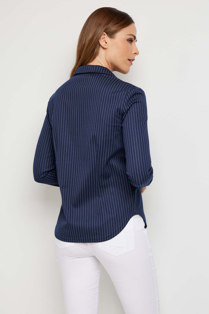 The Best Travel Jacket. Woman Showing the Back Profile of a Verity Jacket in Navy/White.