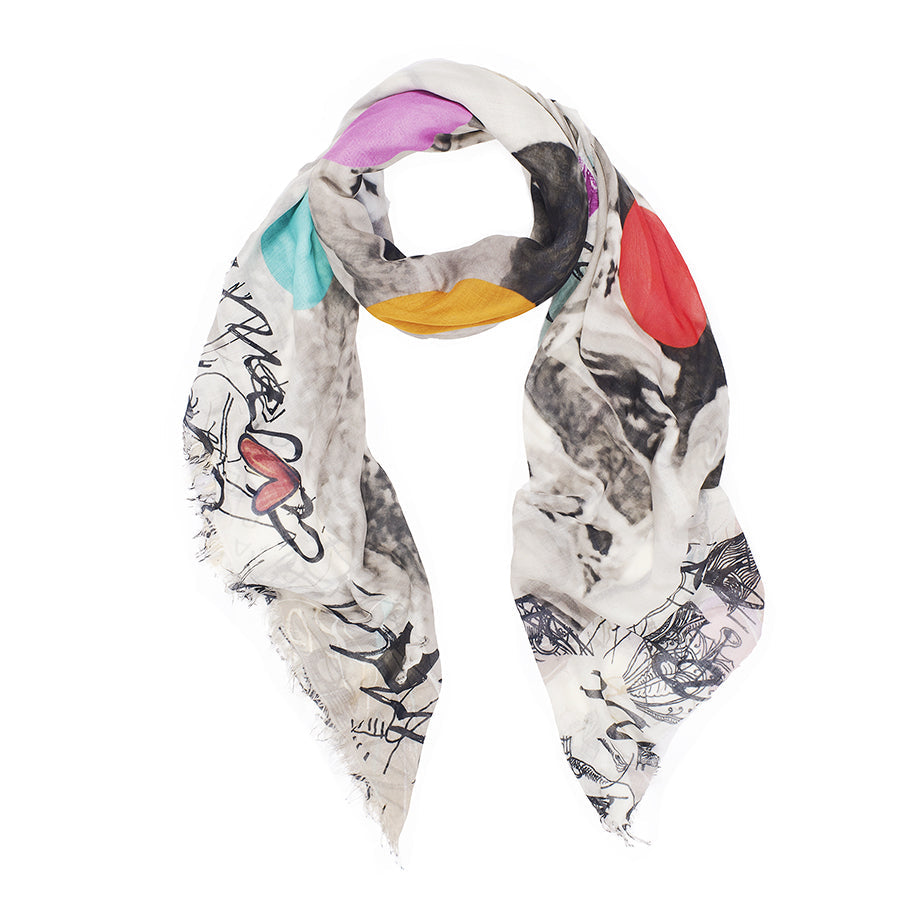 The SUZI ROHER "Because We Love You" scarf is a lightweight white modal silk accessory made in Italy, featuring frayed edges, abstract black and gray patterns, colorful circles, and a heart motif—a chic Jackie Kennedy–inspired piece.