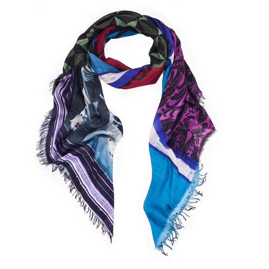 The SUZI ROHER "Captcha" scarf is a multicolored modal silk accessory with geometric, striped, and floral designs in green, red, blue, purple, and black tones, finished with frayed edges.