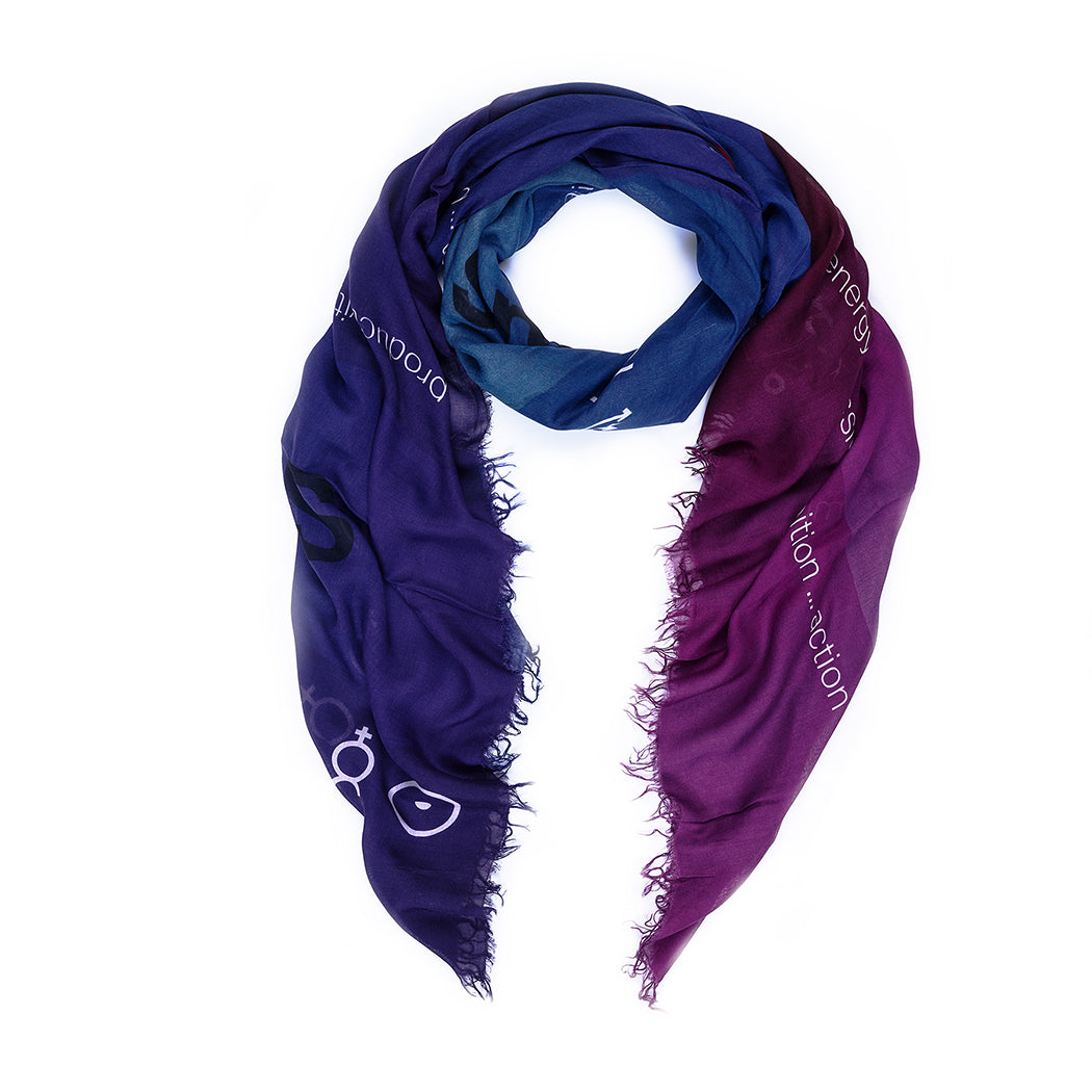 The SUZI ROHER "Planets" scarf is a lightweight silk accessory in gradient blue to purple with frayed edges, white text, and small celestial tapestry symbols, artfully arranged in a loose spiral on a white background.