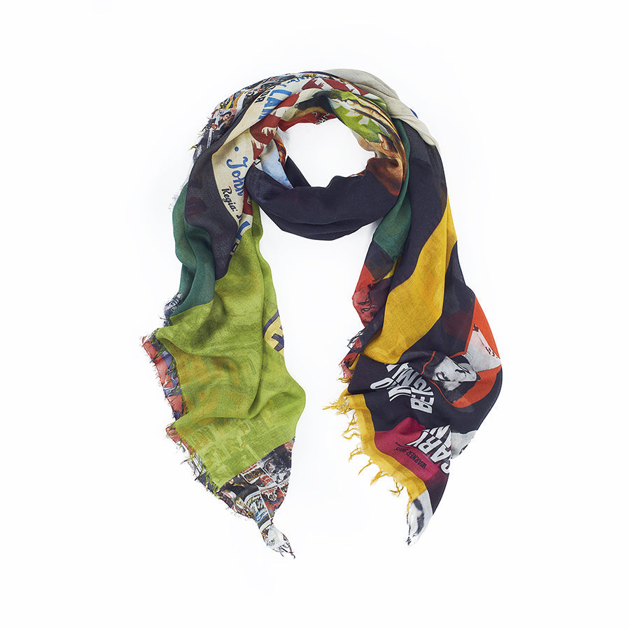 The SUZI ROHER "Rhapsody" is a lightweight modal silk scarf with frayed edges, featuring vibrant patterns and multicolored text, shown loosely coiled on a white background.