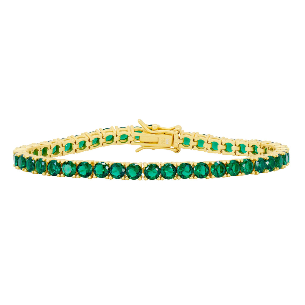 The Midnight Tri-Tone Twilight Tennis Bracelet by Midnight showcases a stunning array of round, vivid green gemstones set continuously in 14K matte gold. The secure clasp adds a decorative touch that complements the bracelet's elegant design.