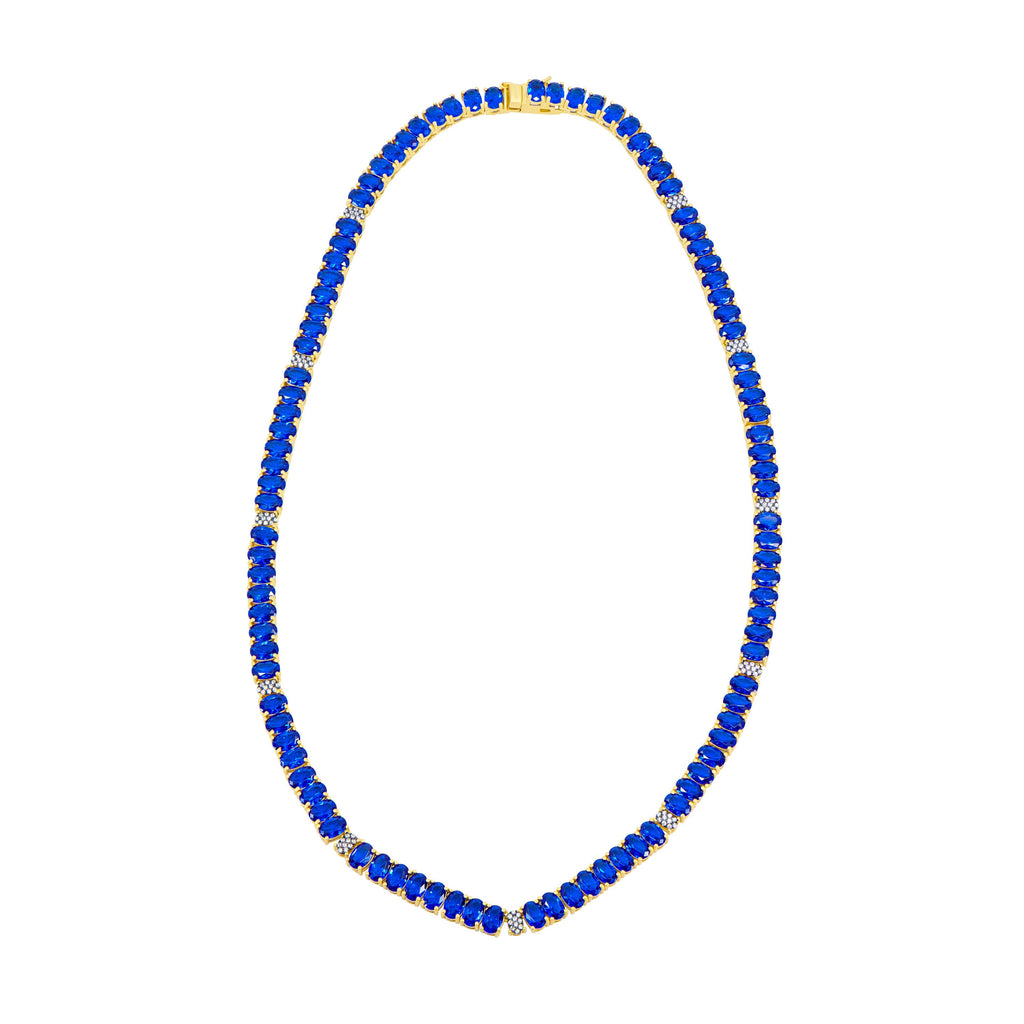 The Midnight Tri-Tone Twilight Oval Station Tennis Necklace by Midnight is a 14K matte gold piece featuring a continuous strand of deep blue gemstones, each evenly spaced and enhanced with small, sparkling cubic zirconia stones. It also includes an elegant clasp at the top for secure wear.