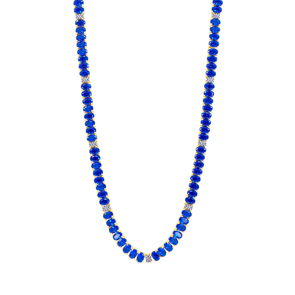 The Midnight Tri-Tone Twilight Oval Station Tennis Necklace, by Midnight, features vibrant blue stones and small silver beads interspersed with 14K matte gold accents. The uniform arrangement exudes a simple yet elegant design, presented against a white background.