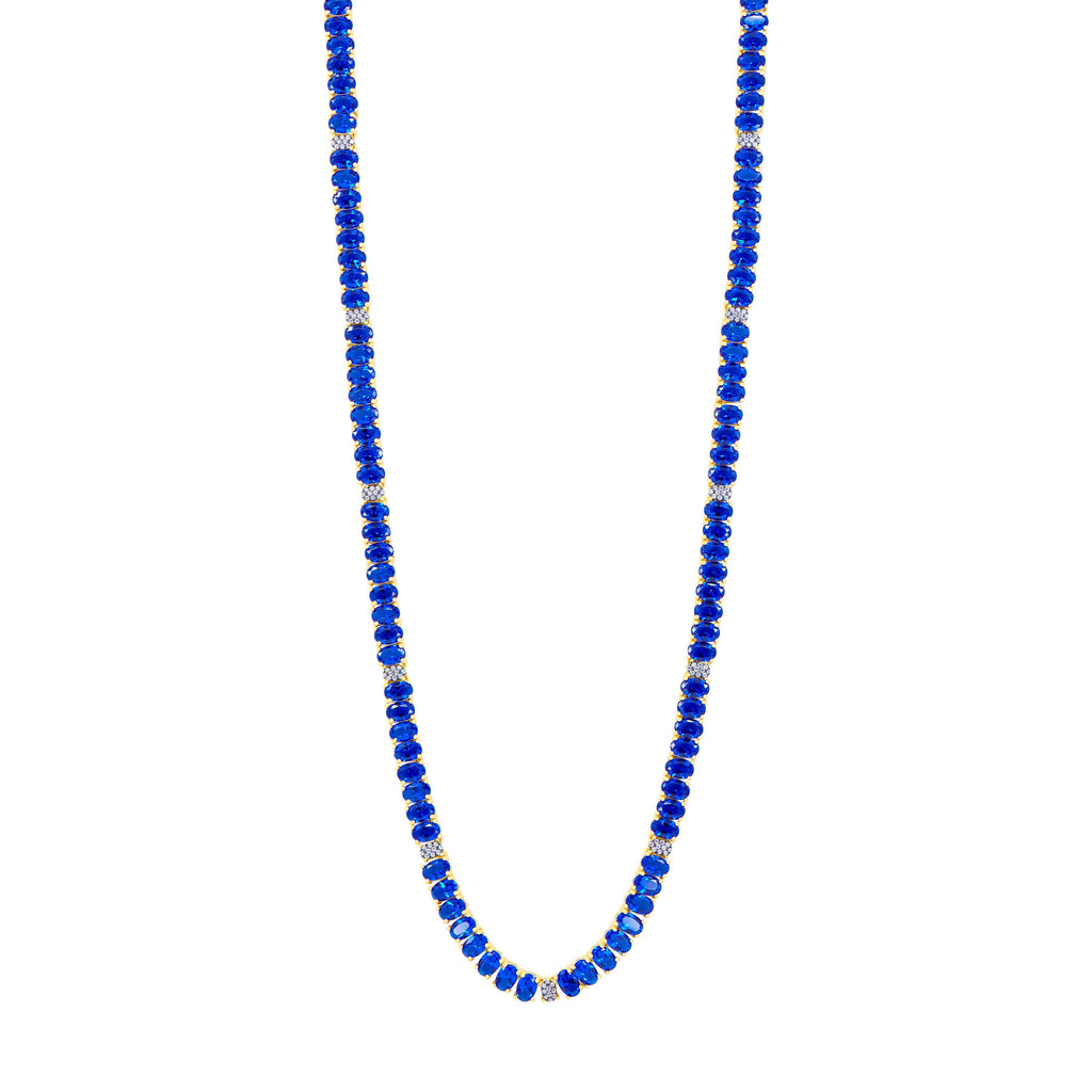 The Midnight Tri-Tone Twilight Oval Station Tennis Necklace by Midnight showcases deep blue beads alternating with 14K matte gold spacers, creating an elegant and evenly spaced design. The uniformly shaped blue beads are beautifully complemented by the small gold spacers, all set against a white background.