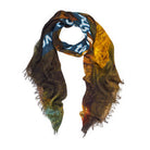 The "Time for the Future" modal silk scarf by SUZI ROHER features frayed edges and an abstract forest-inspired design in yellow, brown, and green with bold blue and white digital-style text across the lightweight fabric.