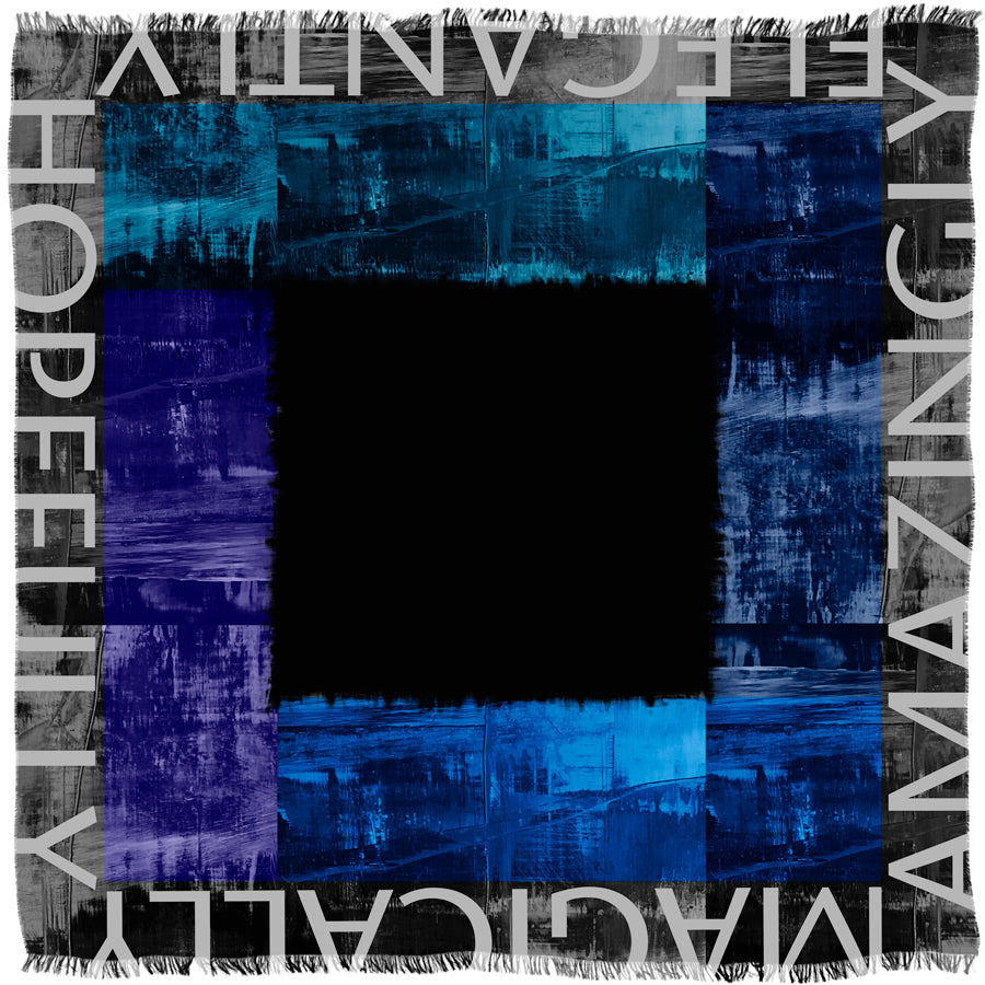 The SUZI ROHER "Elegantly" scarf (145 cm x 145 cm) features abstract blue and black brushstrokes bordering a black center, fringed edges, and bold nine-letter words such as HOPEFULLY and MAGICALLY along the border.