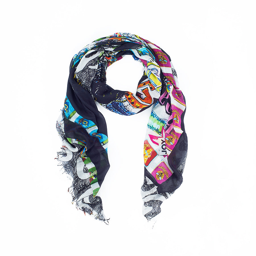 The SUZI ROHER "Perfect Happiness" is a multicolored modal silk scarf with bold graphic patterns and frayed edges, displayed in a circle on white. This luxury accessory features striking contrasts of dark and bright hues.