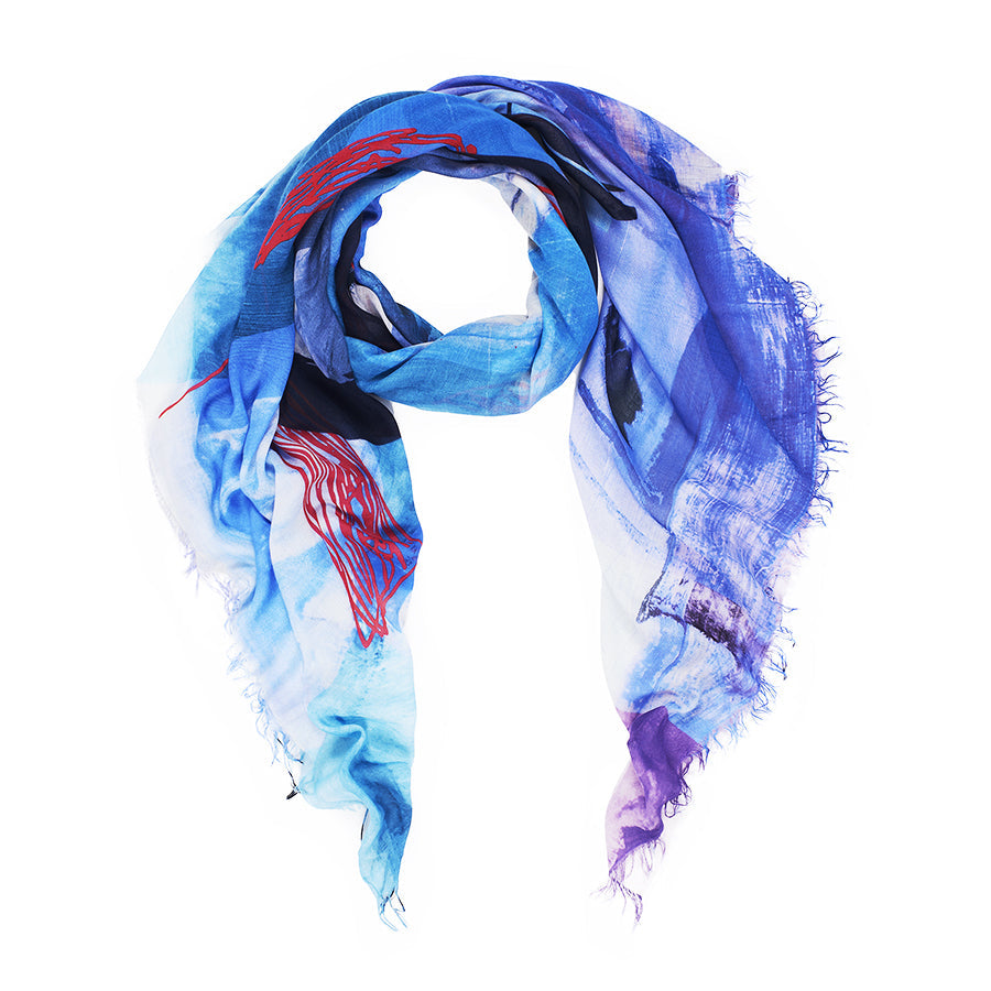 The Kim Soul scarf by SUZI ROHER is a loosely draped, rectangular modal silk piece in blue, purple, white, and red with frayed edges. Made in Italy, it features an abstract painterly pattern crafted with heart and soul.