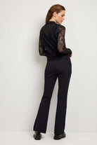 The Best Travel Jacket. Woman Showing the Back Profile of a Bailey Camo Mesh Jacket in Black.