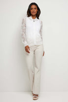 The Best Travel Jacket. Woman Showing the Front Profile of a Bailey Camo Mesh Jacket in White.