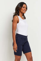 The Best Travel Short. Woman Showing the Side Profile of a Breck Performance Cotton Short in Navy.