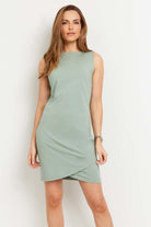 The Best Travel Dress. Woman Showing the Front Profile of a Johanna Dress in Sage.