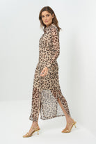 Side view sheer cheetah-print button-down dress featuring a classic collar, long sleeves, and a side slit for added movement. The lightweight fabric 