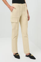 Side view of cream-colored slim-fit cargo pants, featuring a detailed shot of the pockets.