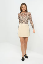 Front view of a skort paired with a cheetah-print long-sleeve top.