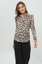 Front view cheetah-print button-down blouse with a classic collar and long sleeves, paired with black utility-style cargo pants featuring flap pockets.