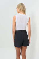 Back view of the skort with a white stripe down the side, paired with a white top.