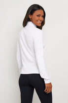 The Best Travel Top. Woman Showing the Side Profile of a Monroe Henley Top in White.