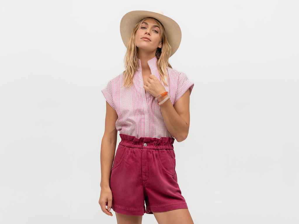 Beautiful woman wearing a short sleeve designer shirt with pink polka dots