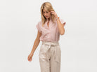Model wearing an upscale short sleeve shirt with pink and shite vertical stripes