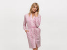Beautiful woman wearing a designer pink and white polkadot shirt dress