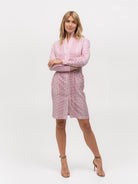 Woman wearing a pink polka dot shirt dress with heels