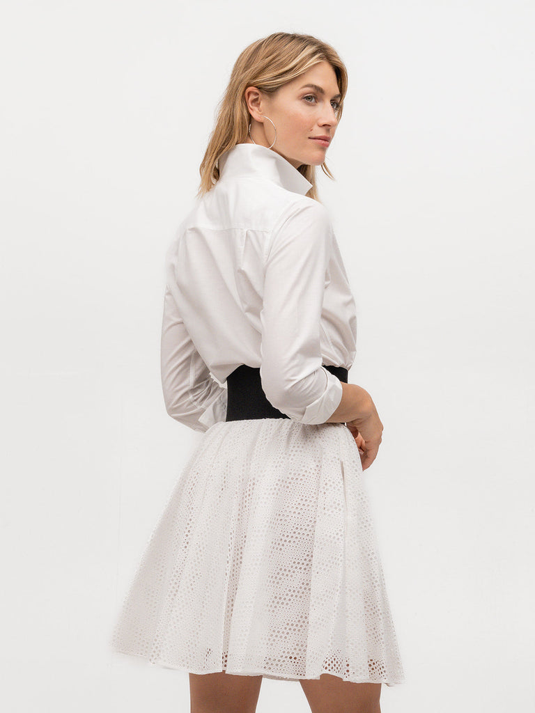 Back of woman wearing an upscale women's dress shirt in white cotton linen fabric