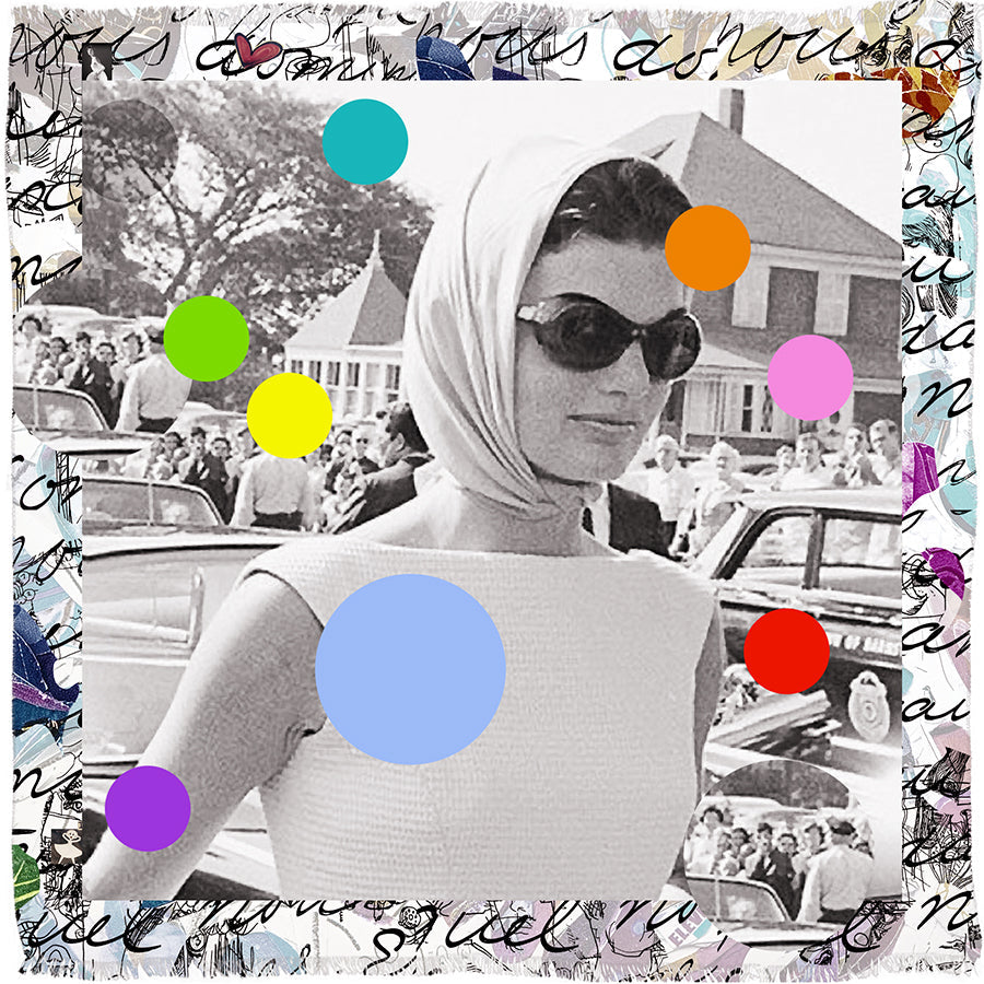 A stylish woman in the SUZI ROHER "Because We Love You" modal silk scarf and sunglasses stands by vintage cars, surrounded by a crowd. Colorful dots and a handwriting-style border echo timeless Jackie Kennedy elegance.