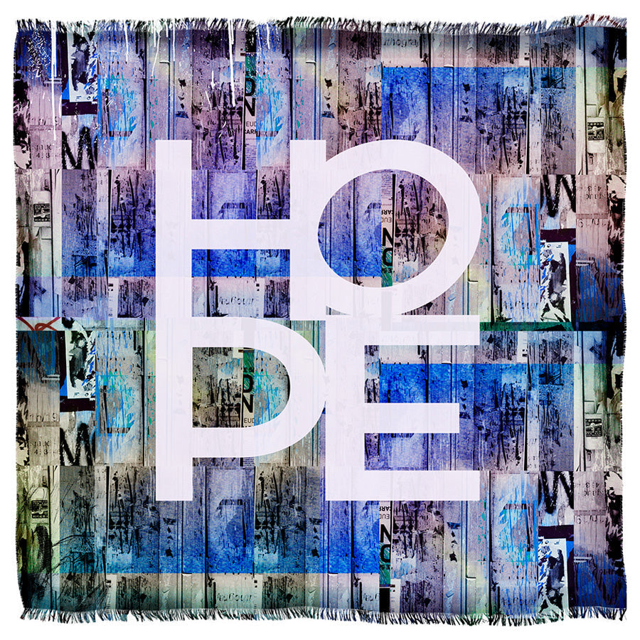 The SUZI ROHER "Hungry for Hope Blues" tapestry showcases the word HOPE in bold white letters on a blue and purple striped, abstract background, radiating optimism.
