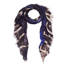 The SUZI ROHER Elegantly scarf is a 145 x 145 cm modal silk accessory featuring frayed edges and an abstract black, beige, and blue pattern on white—perfect for adding distinctive flair to any outfit.