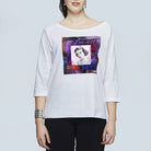 A woman wears SUZI ROHER's The Bailey, an oversized white long-sleeve shirt featuring a colorful vintage magazine cover graphic with a black-and-white woman and "Art of Beauty" text on the front.