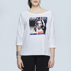A woman wears The Bailey by SUZI ROHER—a white, oversized boxy tee with three-quarter sleeves and a vibrant BIZZARE ART collage on the front—styled with black pants and a silver bracelet.