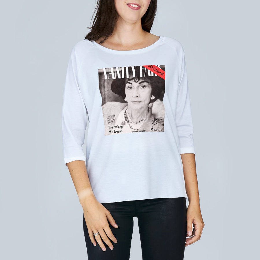 A woman wears The Bailey by SUZI ROHER—a boxy cut tee with three-quarter sleeves, boat neckline, and a chic black-and-white print inspired by VANITY FAIR and Coco Chanel.