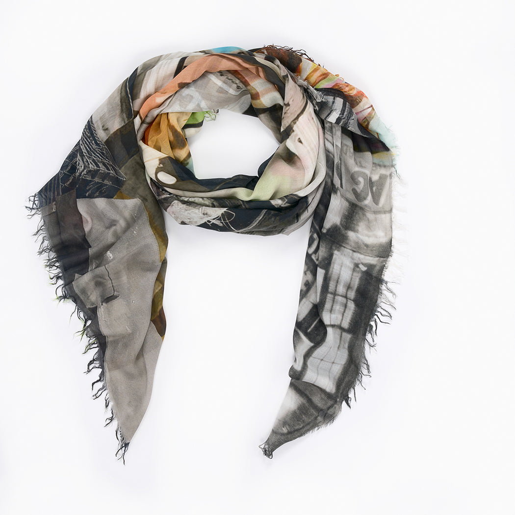 The SUZI ROHER L'Officiel scarf is a lightweight Modal Silk accessory with multicolored abstract patterns and frayed edges, styled in a loose loop on white—a true nod to French fashion magazine elegance.