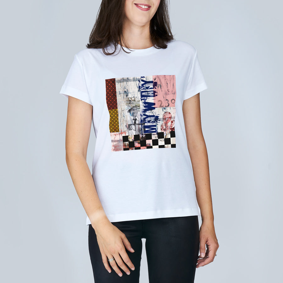 A woman wears The Niki t-shirt by SUZI ROHER, featuring a colorful abstract design inspired by "My Way" and the text ONLY MAKE on the front, paired with black pants against a light gray background.